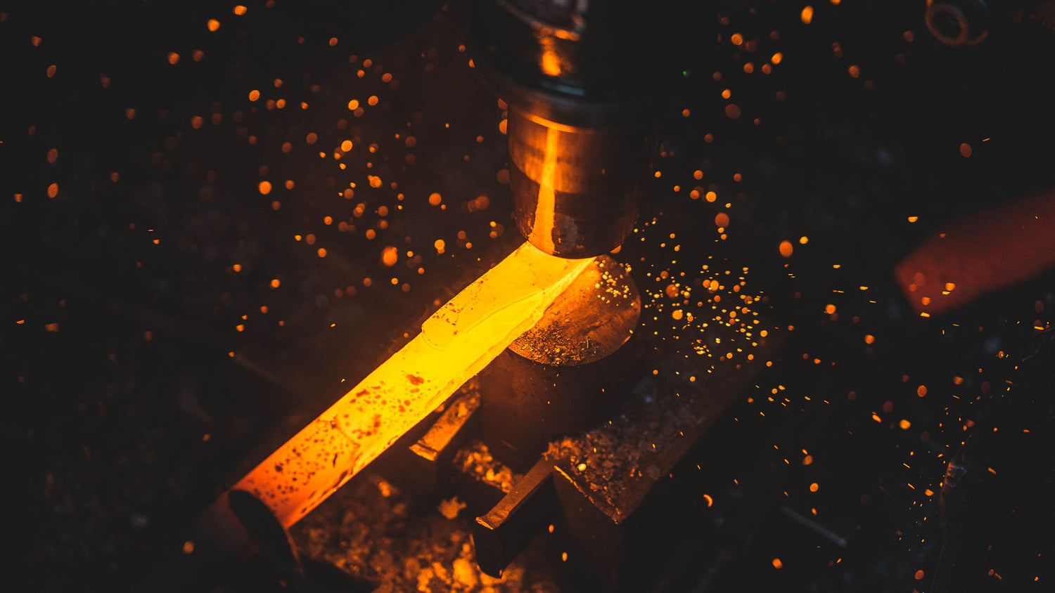 Japanese blacksmith forging a kitchen knife